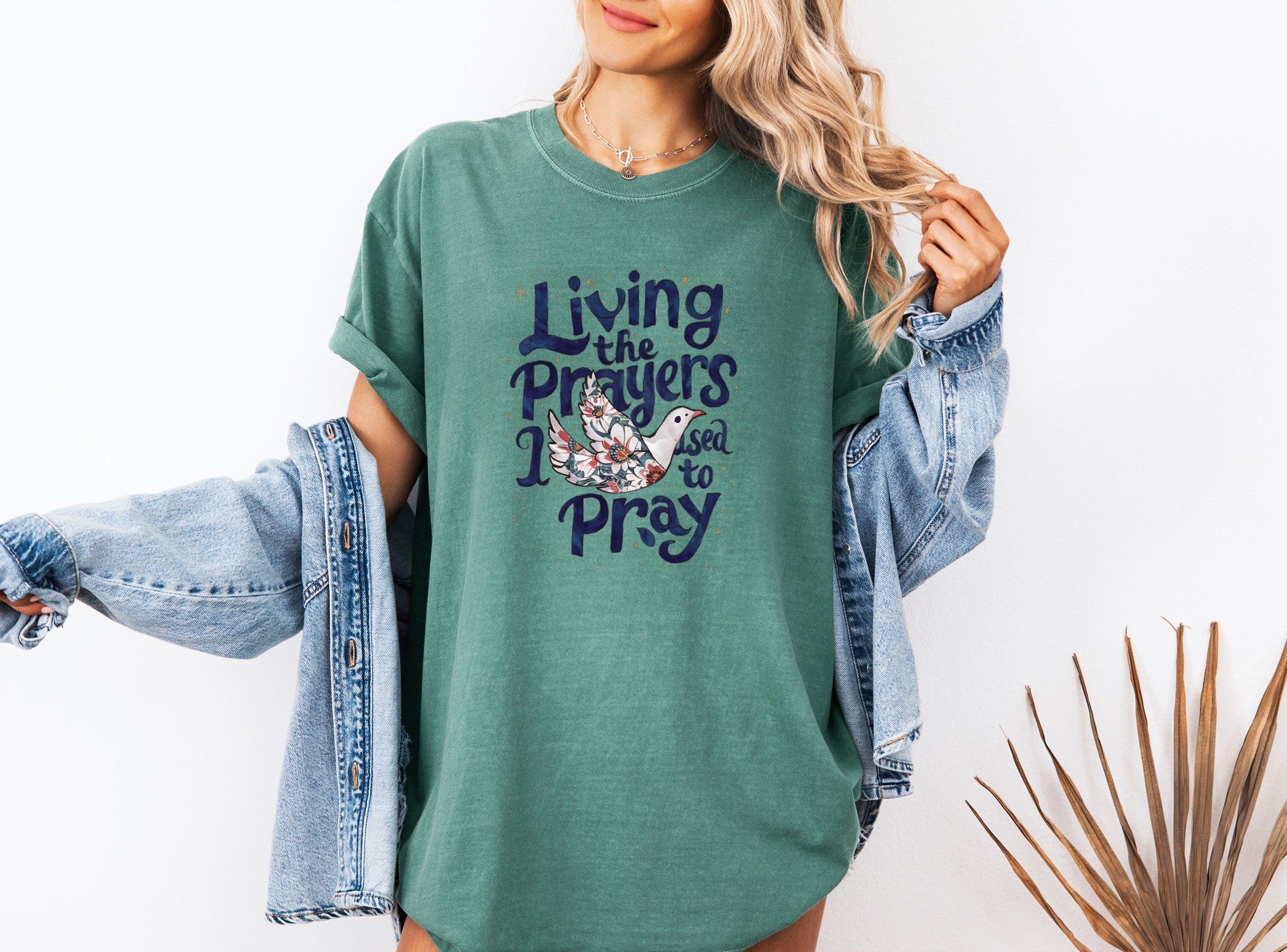 Green unisex t-shirt with “Living the Prayers…Pray” front graphic