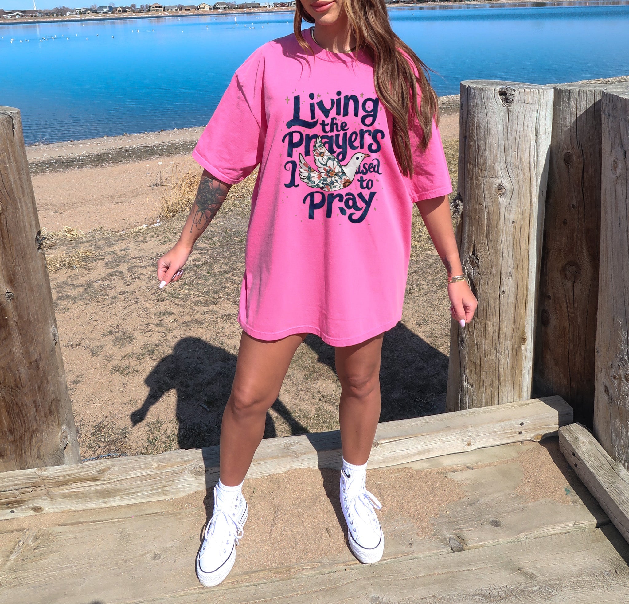 Hot pink unisex t-shirt with “Living the Prayers…Pray” front graphic