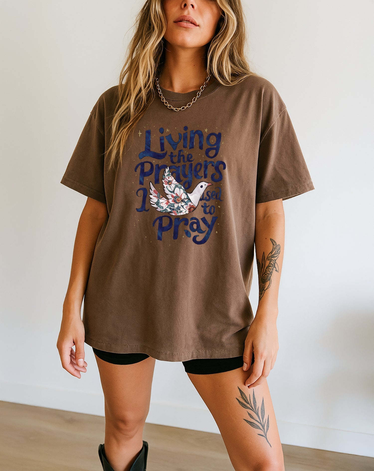Espresso brown unisex t-shirt with “Living the Prayers…Pray” front graphic