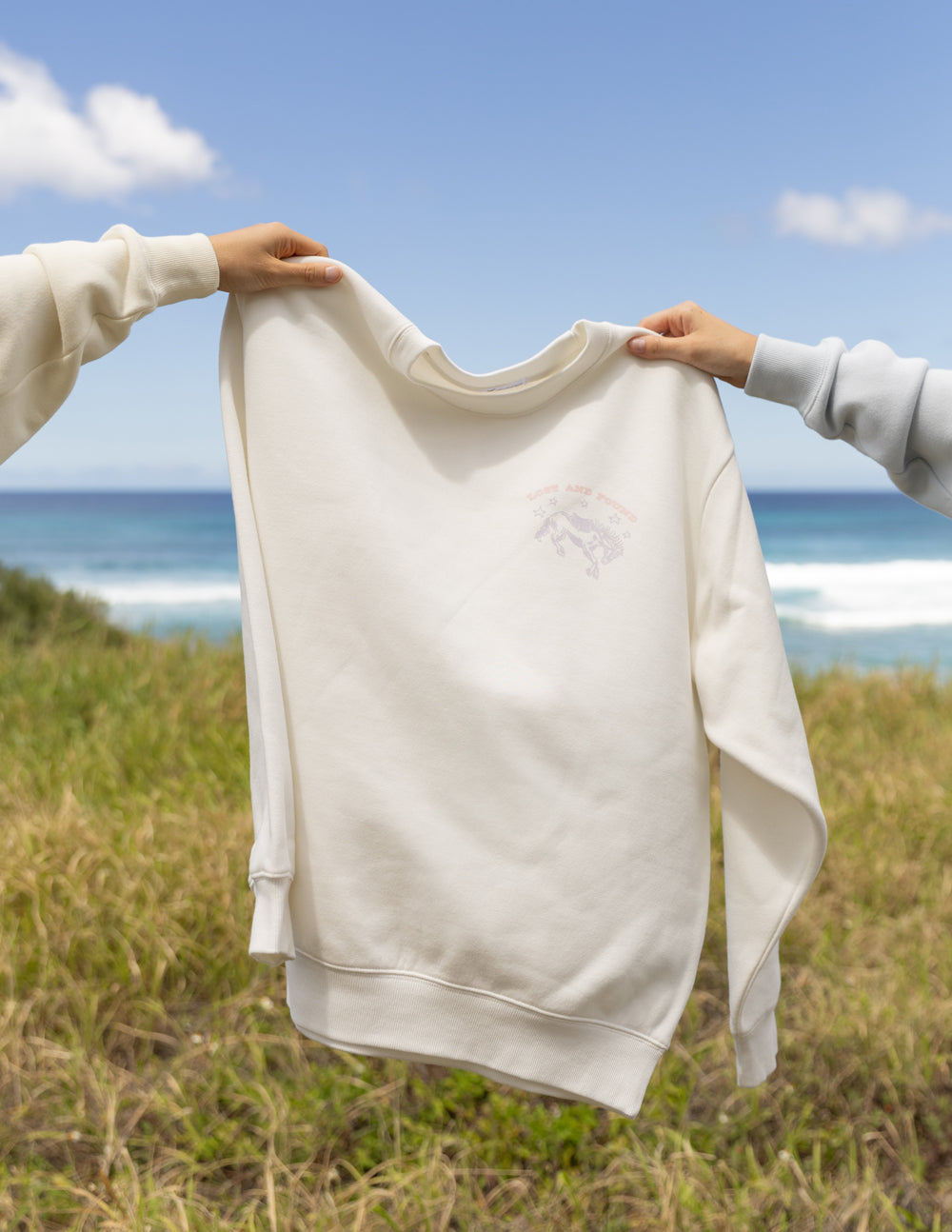 Unisex crewneck sweatshirt, light cream front with small logo graphic