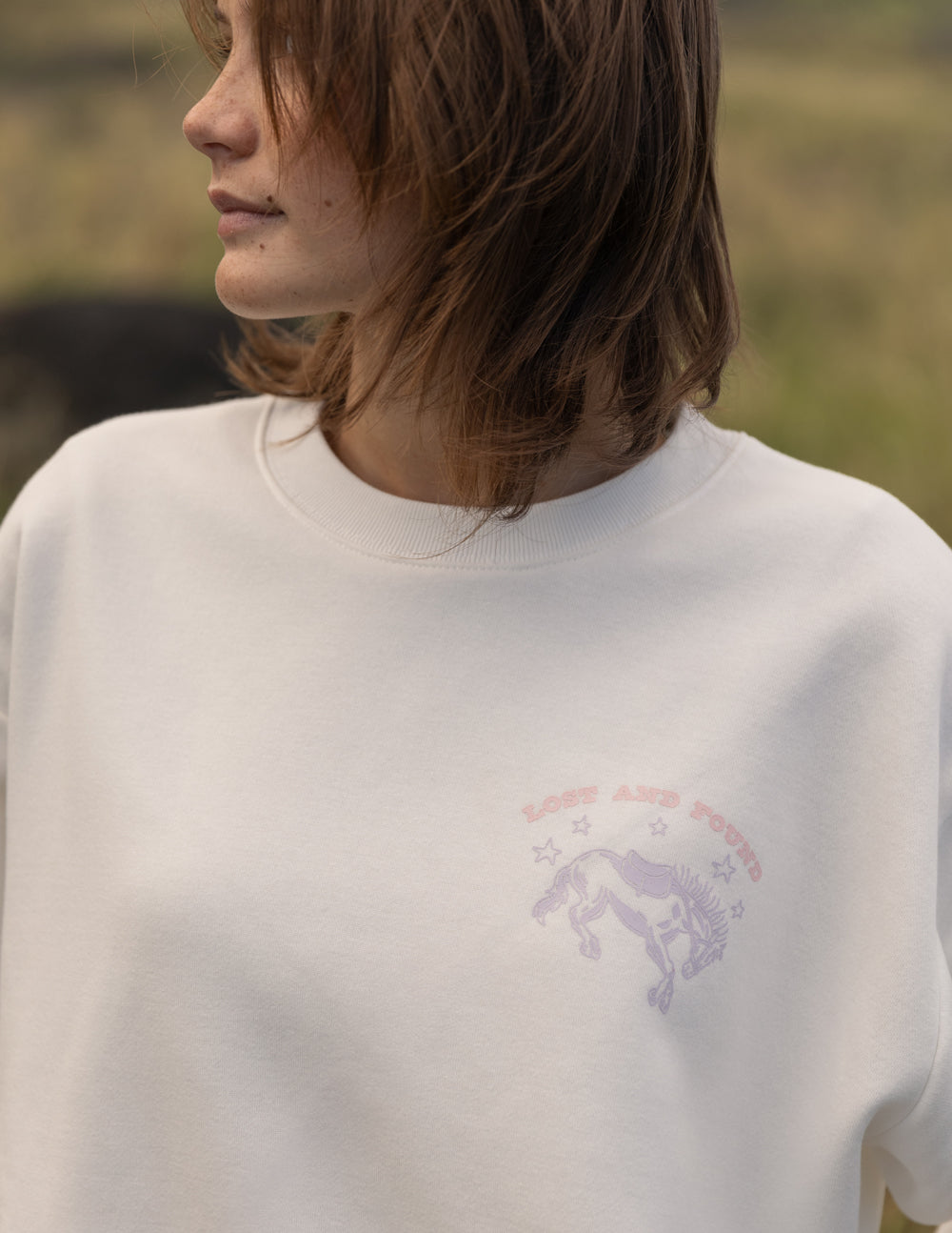Unisex crewneck sweatshirt, light cream with small chest logo detail