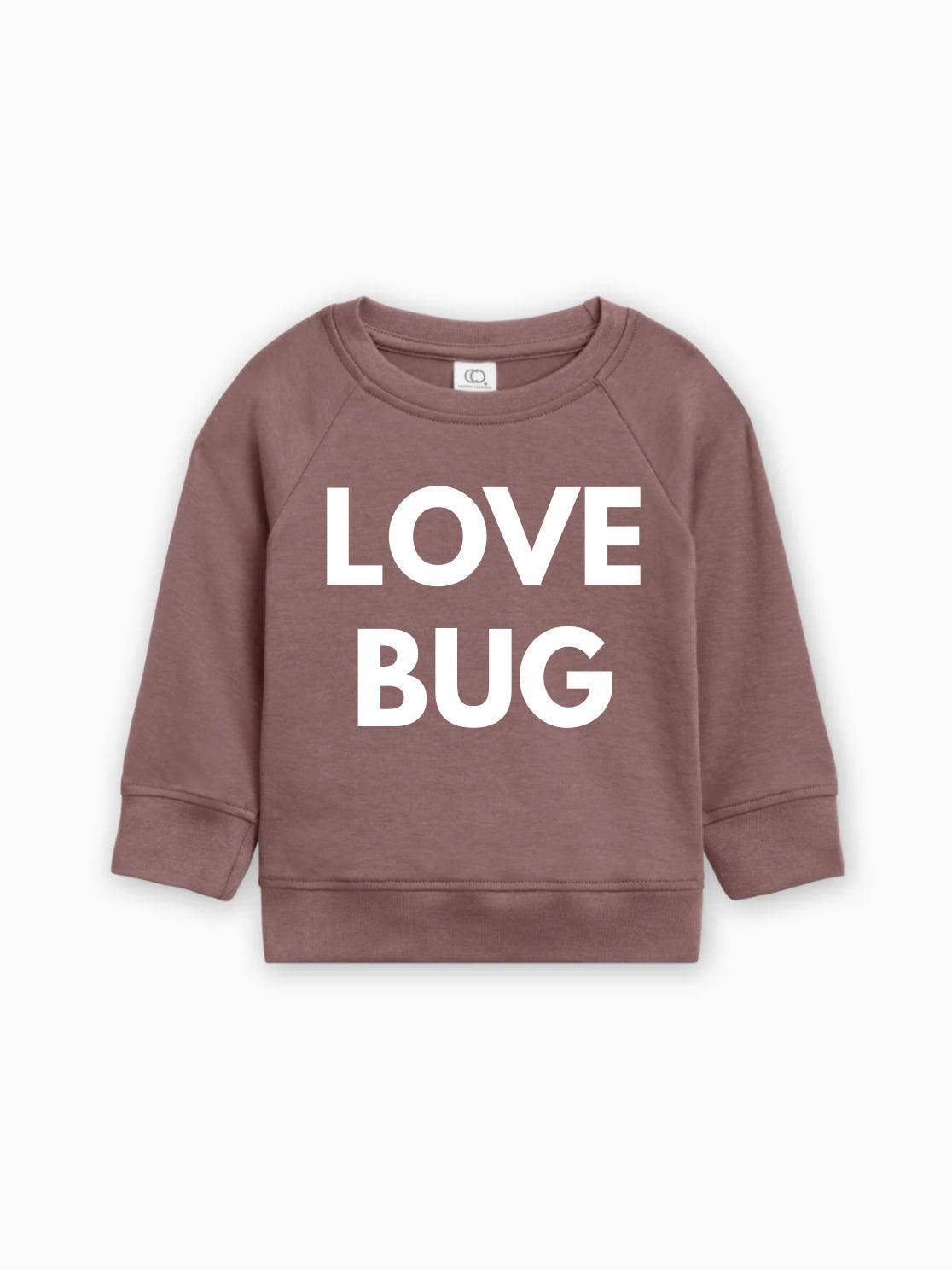 Mauve baby pullover with white “LOVE BUG” text graphic