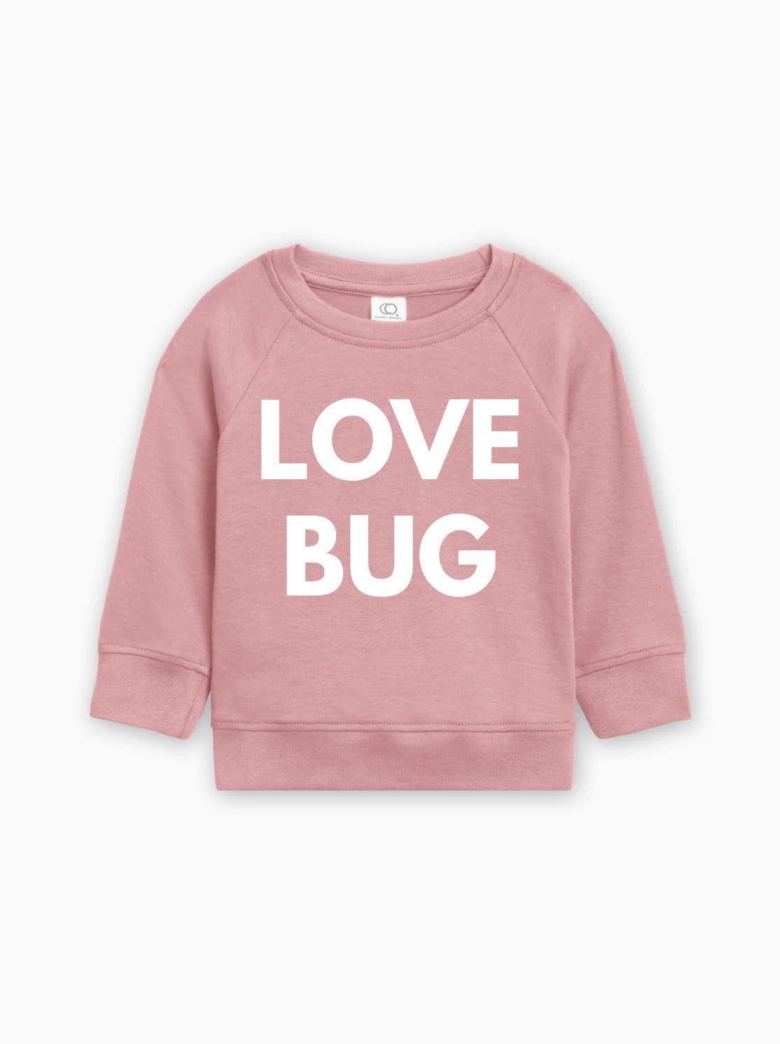 Pink baby pullover with white “LOVE BUG” text graphic