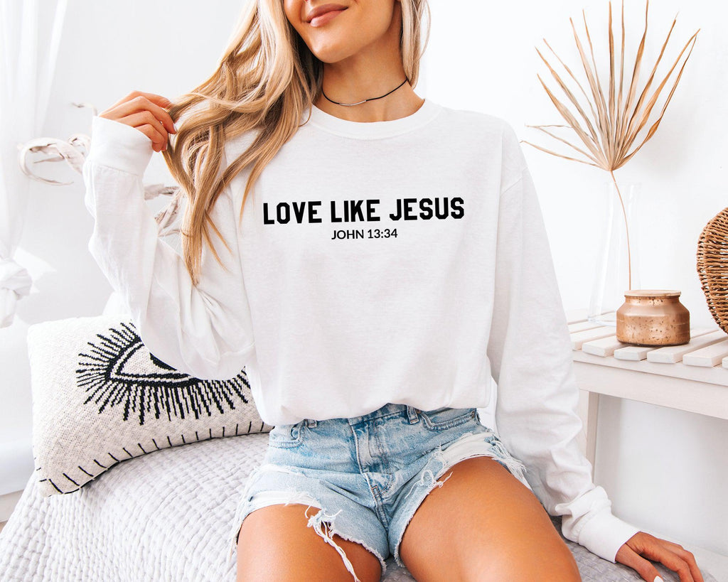 White long sleeve shirt with 'LOVE LIKE JESUS' and 'JOHN 13:34' on front