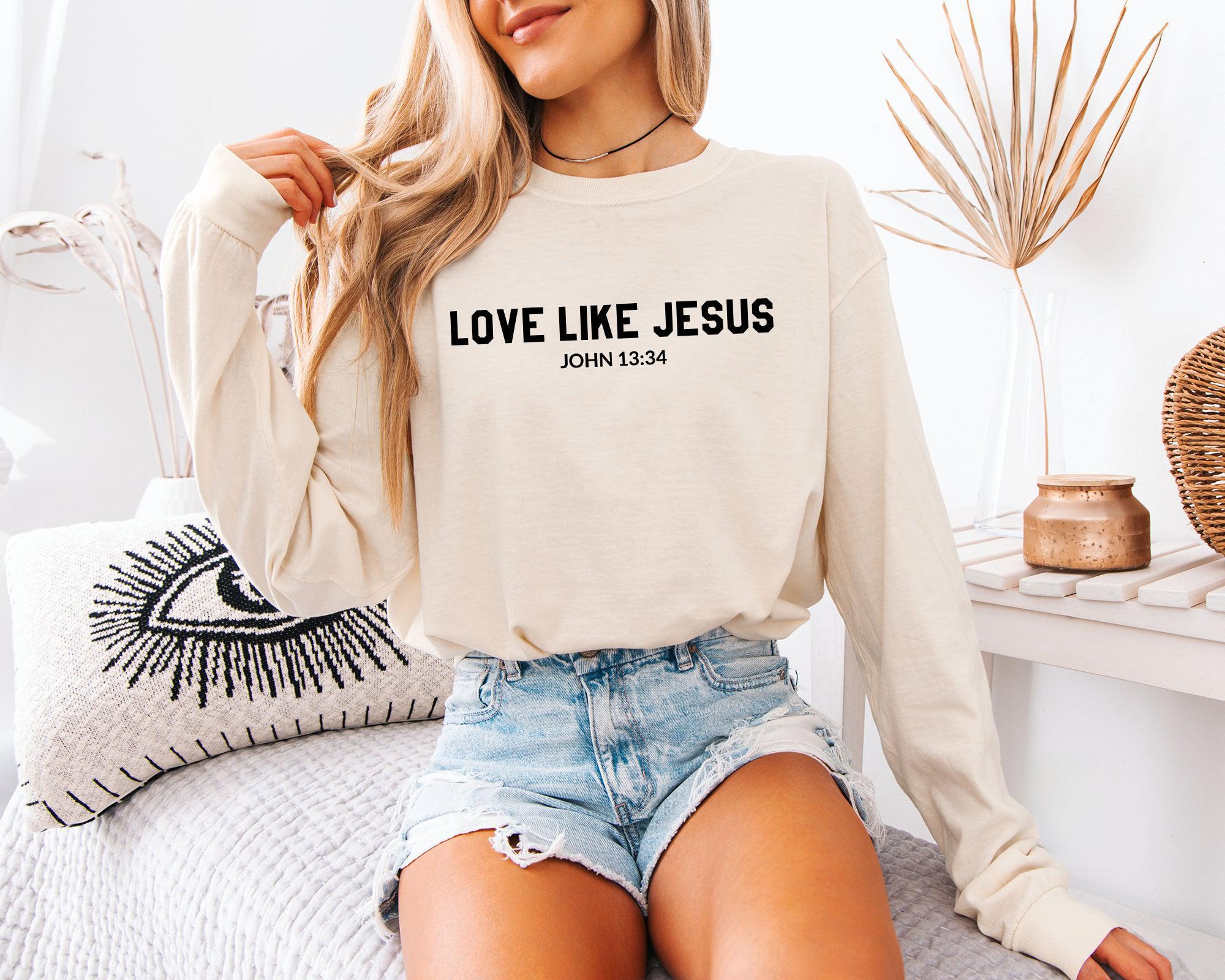 Ivory long sleeve shirt with 'LOVE LIKE JESUS' and 'JOHN 13:34' on front