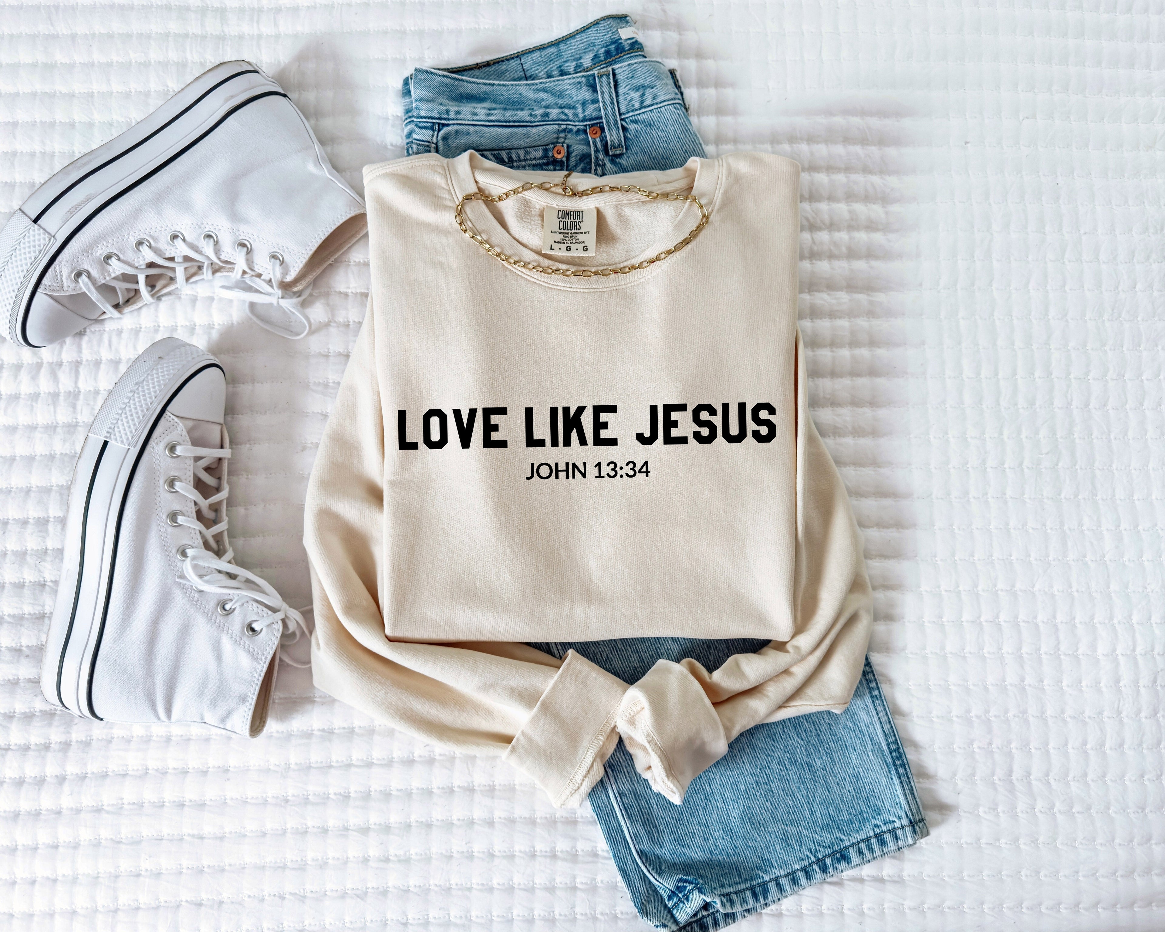 Ivory crewneck sweatshirt with “LOVE LIKE JESUS” and “John 13:34” print