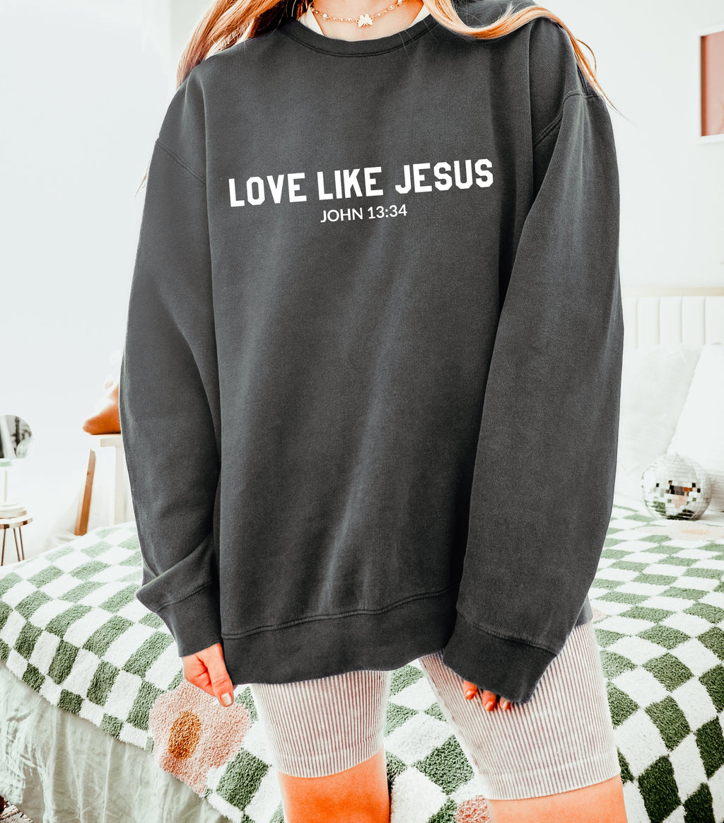 Black crewneck sweatshirt with “LOVE LIKE JESUS” and “John 13:34” print