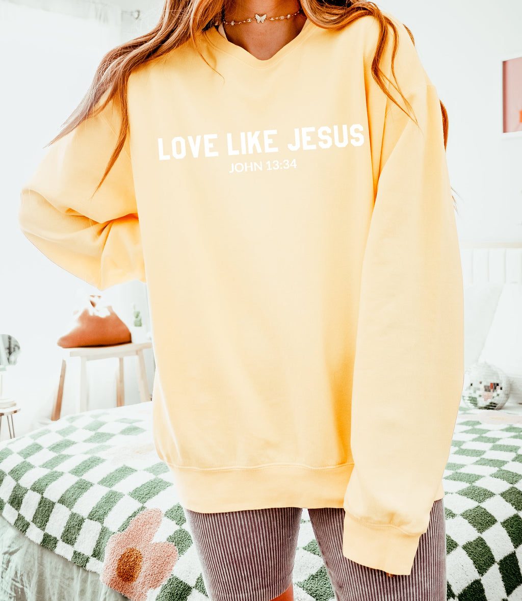 Butter yellow crewneck sweatshirt with “LOVE LIKE JESUS” and “John 13:34” print