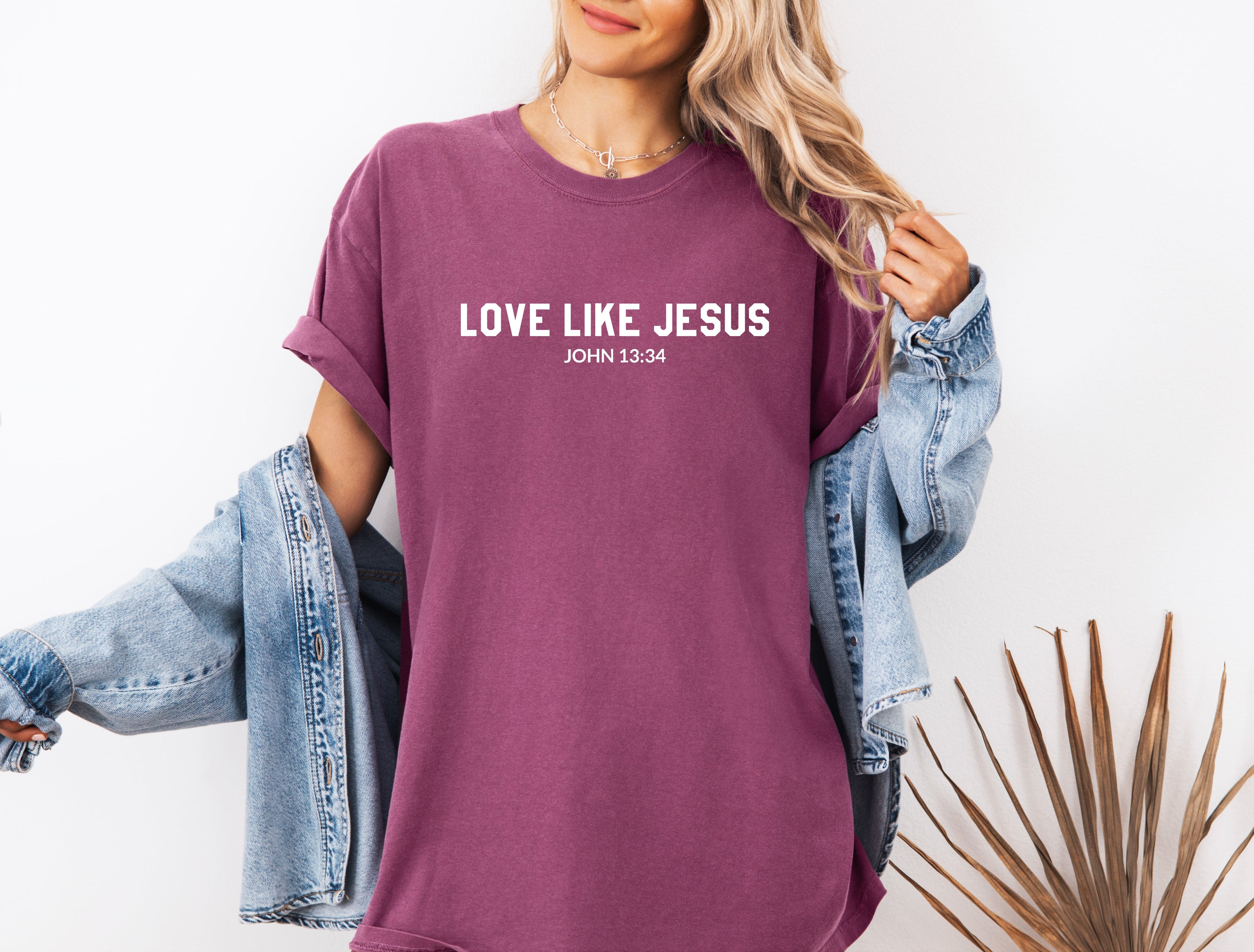 Purple crew-neck Christian graphic T-shirt with “LOVE LIKE JESUS” text on chest