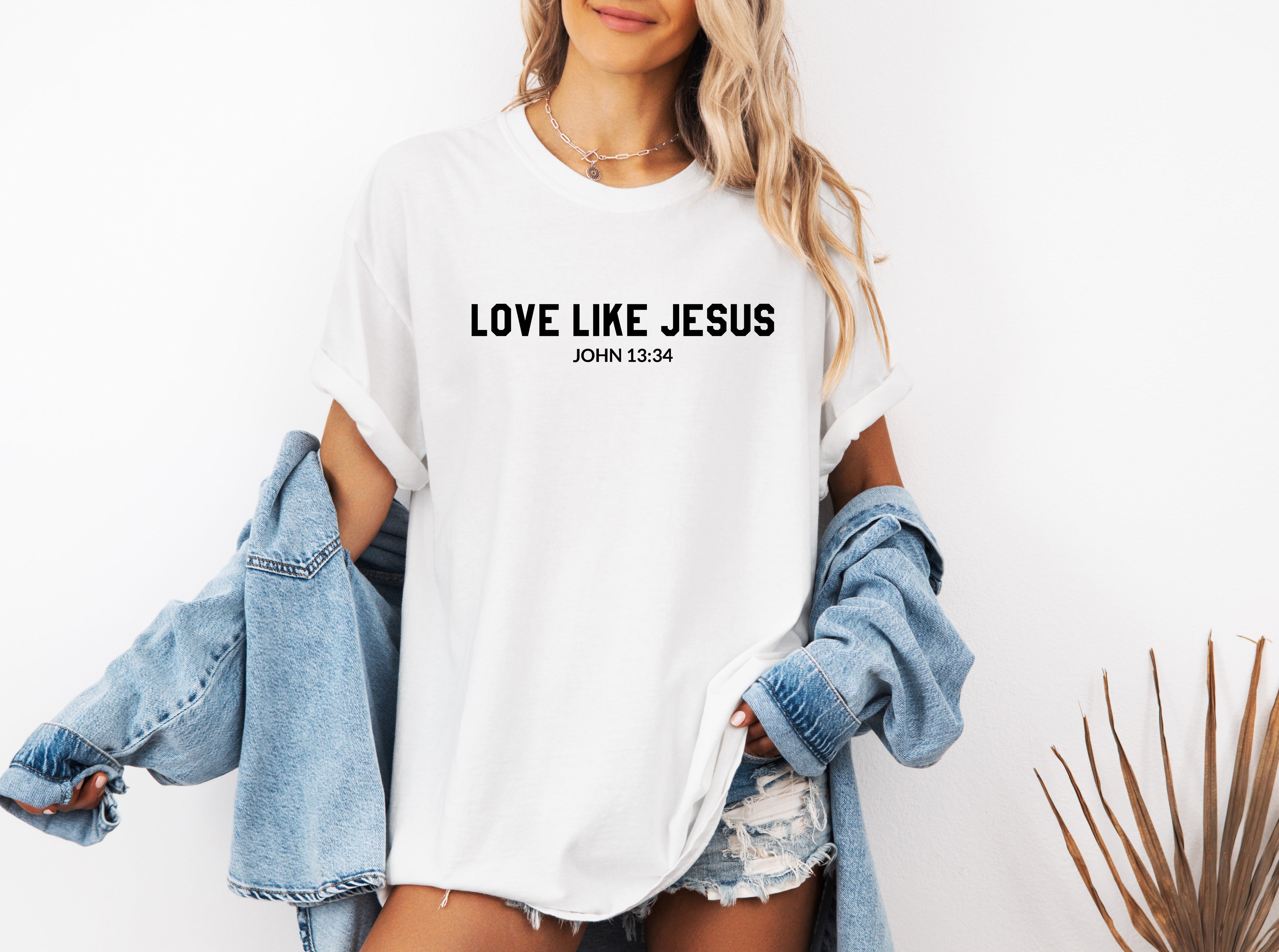 White crew-neck Christian graphic T-shirt with “LOVE LIKE JESUS” text on chest