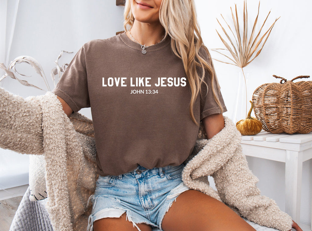 Brown crew-neck Christian graphic T-shirt with “LOVE LIKE JESUS” text on chest