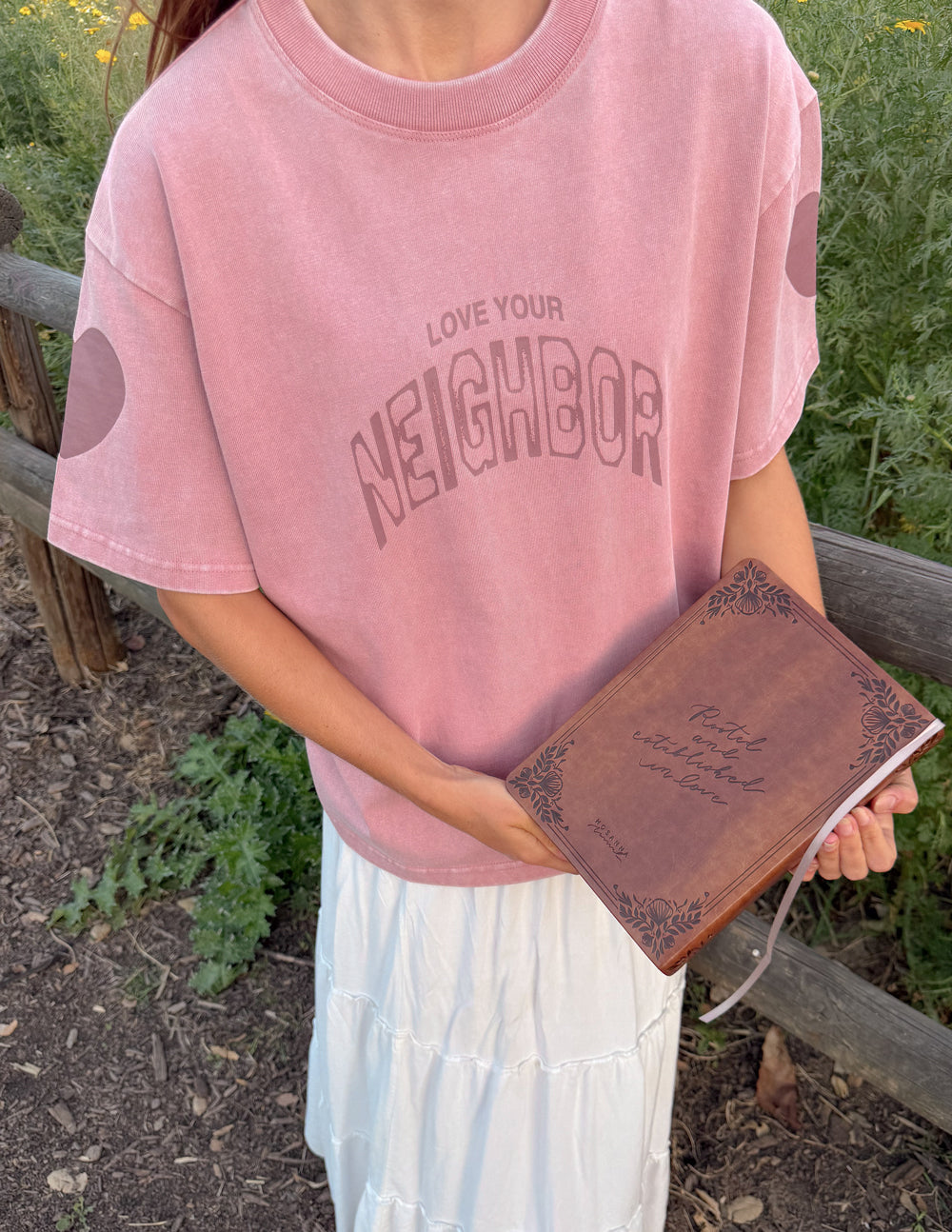 Pink heavyweight T-shirt with crew neck and 'Neighbor' front graphic logo
