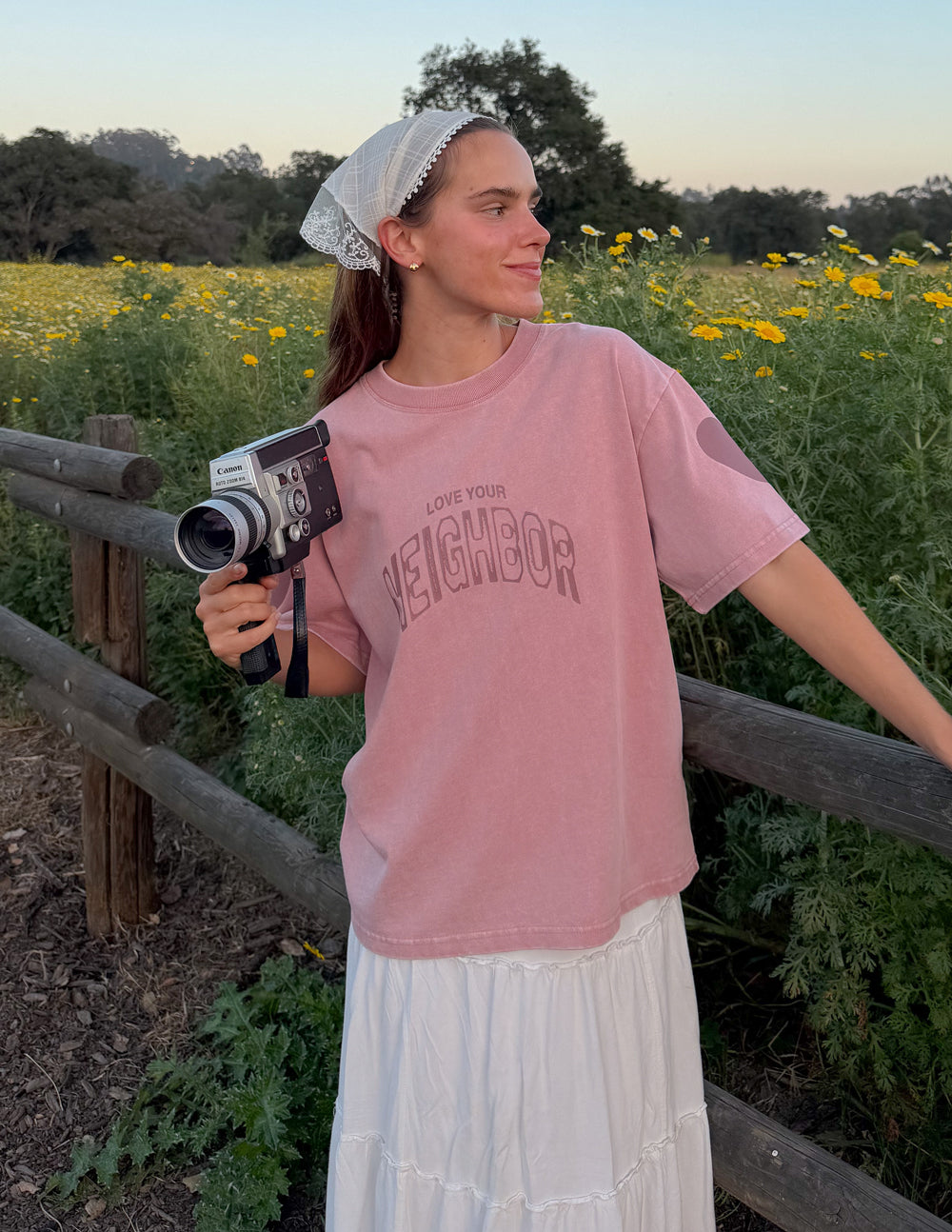 Pink heavyweight T-shirt with crew neck and large 'Neighbor' front graphic logo