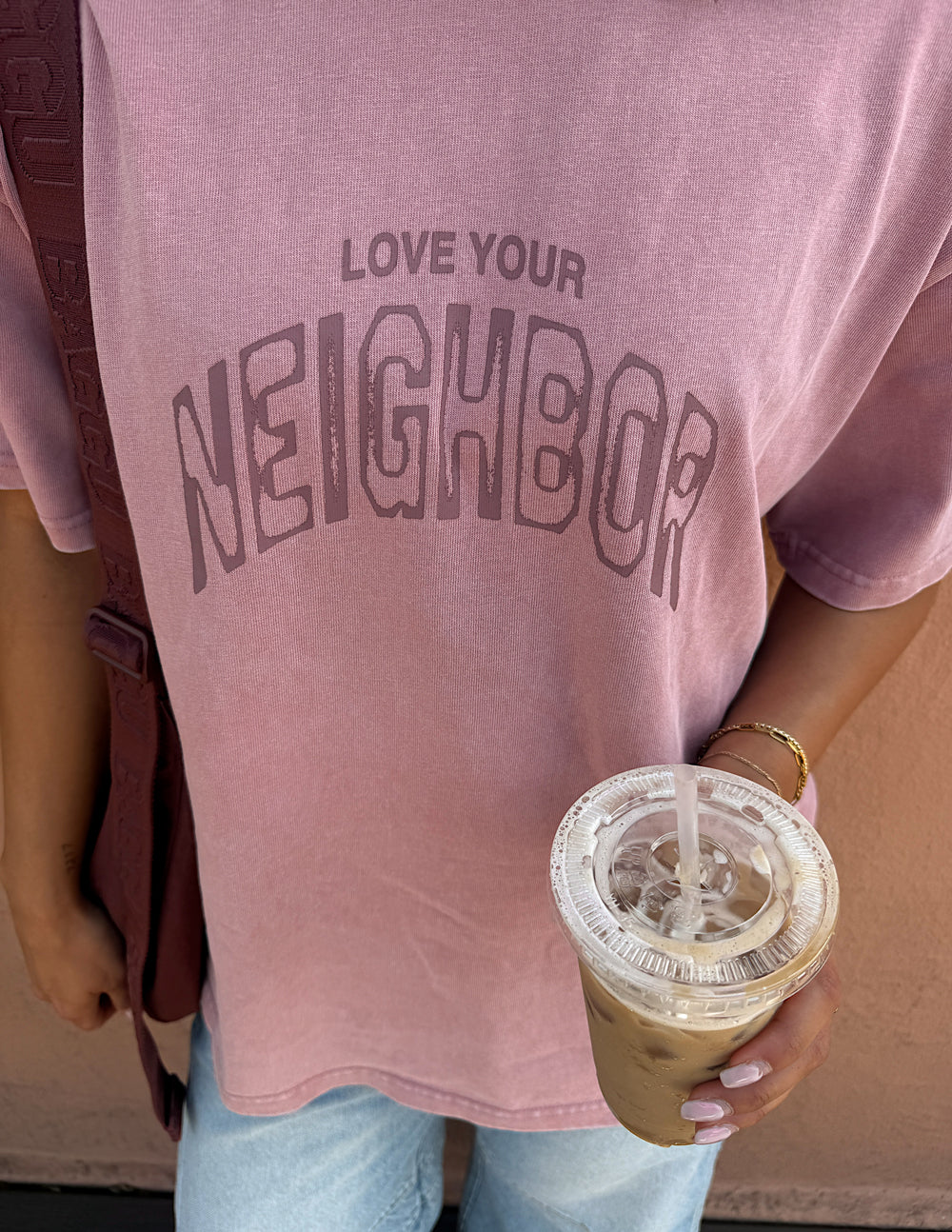 Pink heavyweight crewneck tee with large Love Your Neighbor graphic