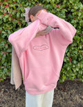 Pink unisex hoodie with hood and kangaroo pocket, with heart-shaped “Love Yourself” logo.