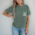 Short-sleeve pocket T-shirt, moss green, with “LOVE LIKE JESUS” logo on chest.