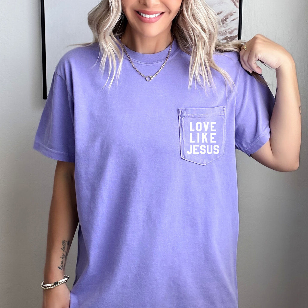 Short-sleeve pocket T-shirt, lavender, with “LOVE LIKE JESUS” logo on the chest pocket.