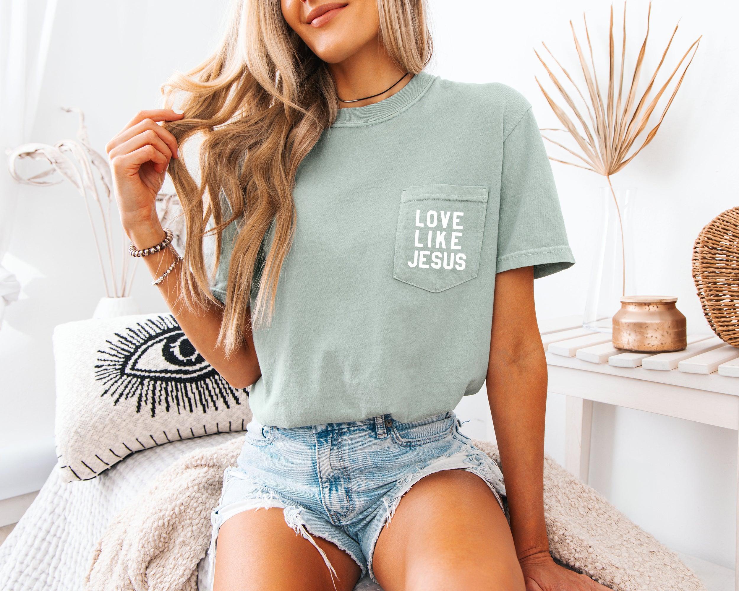 Short-sleeve pocket T-shirt, sage green, with “LOVE LIKE JESUS” logo on chest pocket.