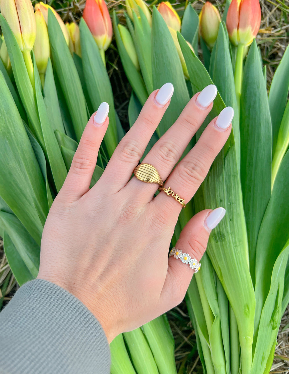 Gold-tone Loved ring on finger with small linked detail