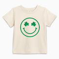 Natural baby T-shirt with green smiley clover face graphic, short sleeves