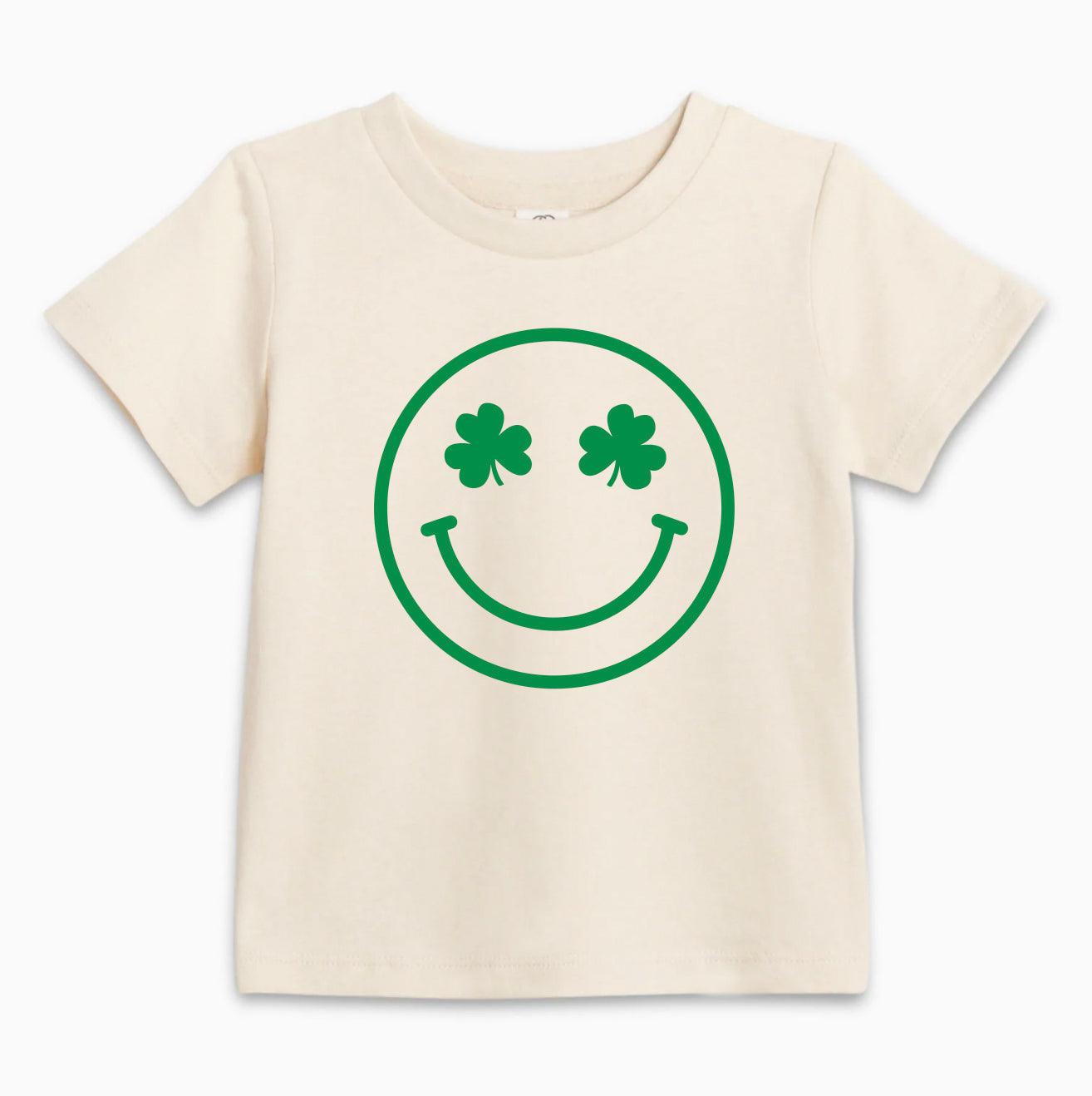 Natural baby T-shirt with green smiley clover face graphic, short sleeves