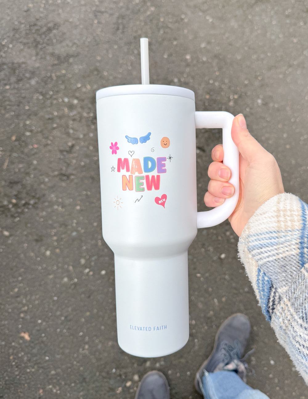 White 40 oz tumbler with handle and straw lid, “Made New” graphic on front