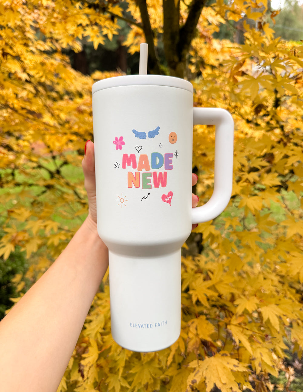 White 40 oz tumbler with handle and straw lid; “Made New” graphic on front
