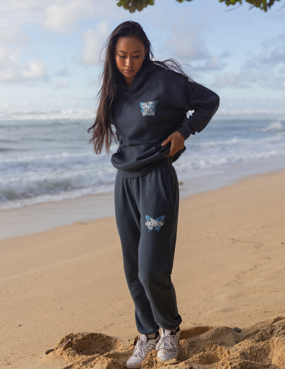 Unisex dark navy hoodie with small chest logo, front pocket and drawstring hood