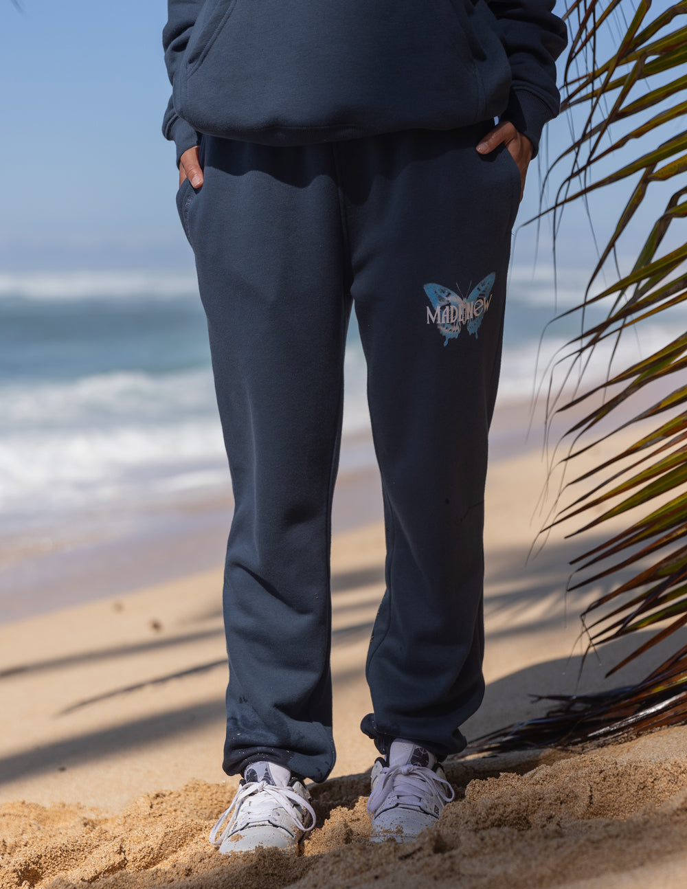 Navy unisex sweatpants with butterfly logo on thigh and elastic ankle cuffs