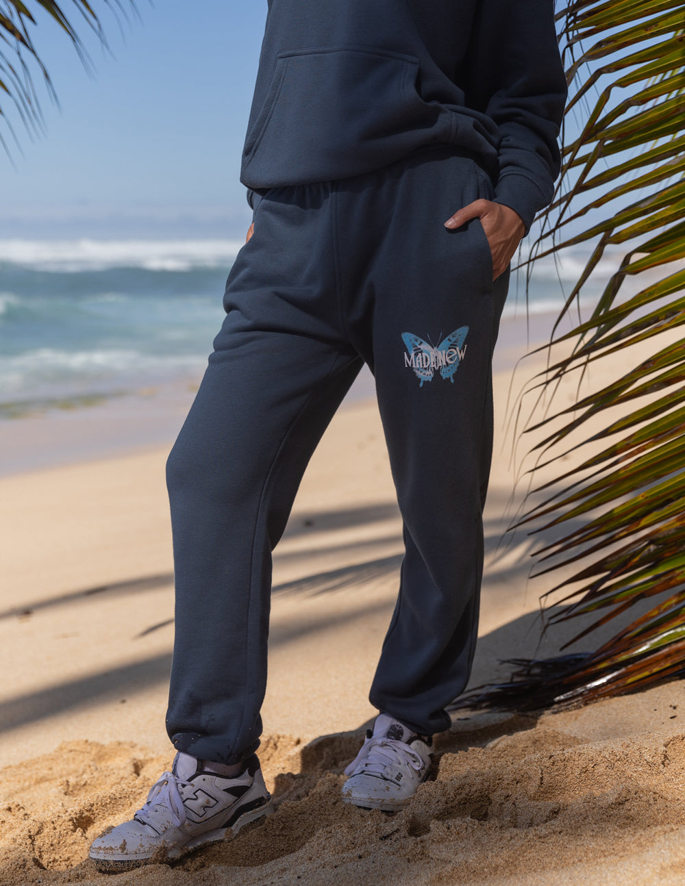 Navy unisex sweatpants with butterfly graphic on thigh and elastic ankle cuffs