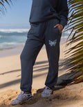 Navy unisex sweatpants with butterfly graphic on thigh and elastic ankle cuffs