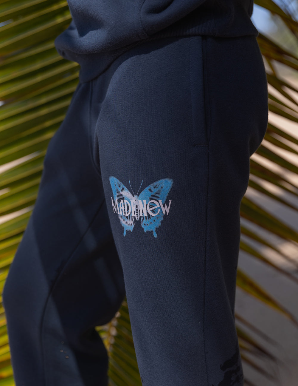 Navy unisex sweatpants with butterfly logo graphic on side panel