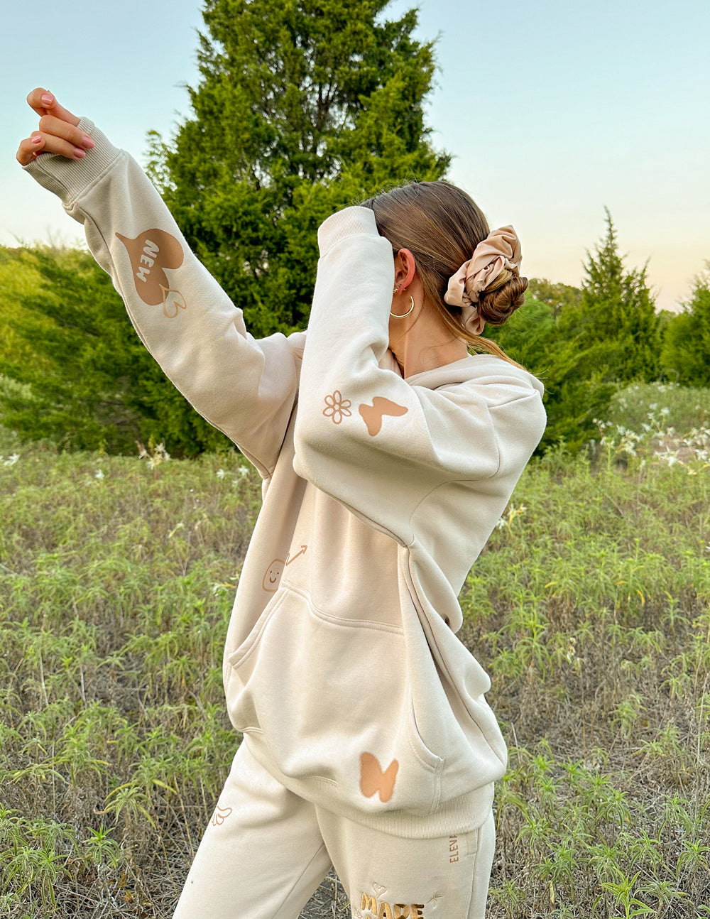 Cream unisex hoodie with hood and printed back and sleeve graphics