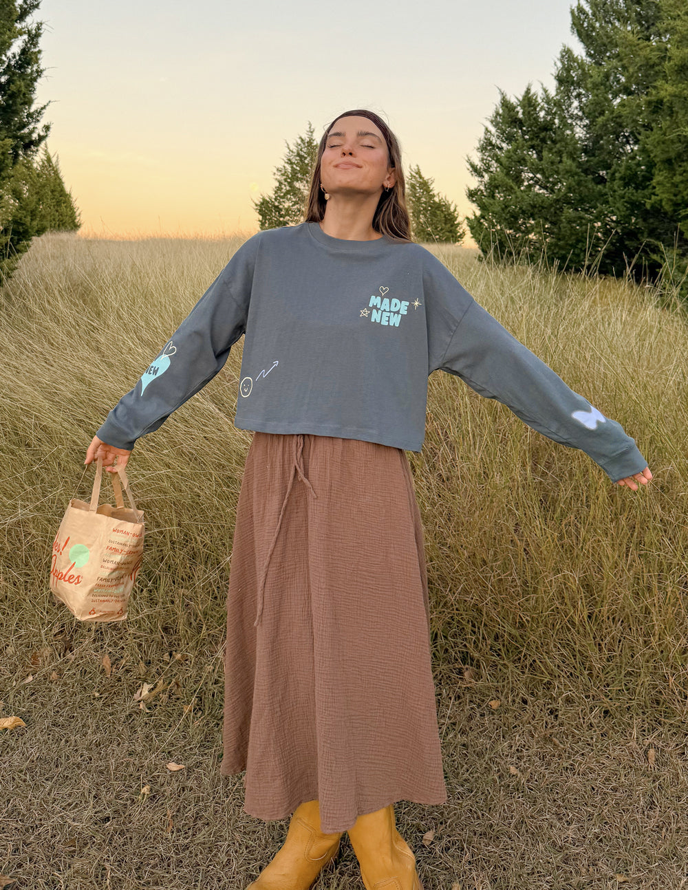 Cropped long-sleeve tee in dark blue with “MADE NEW” chest logo