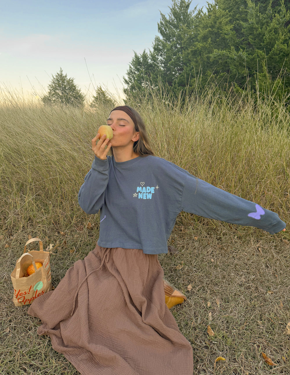 Cropped long-sleeve tee in dark blue with “MADE NEW” logo and small sleeve heart