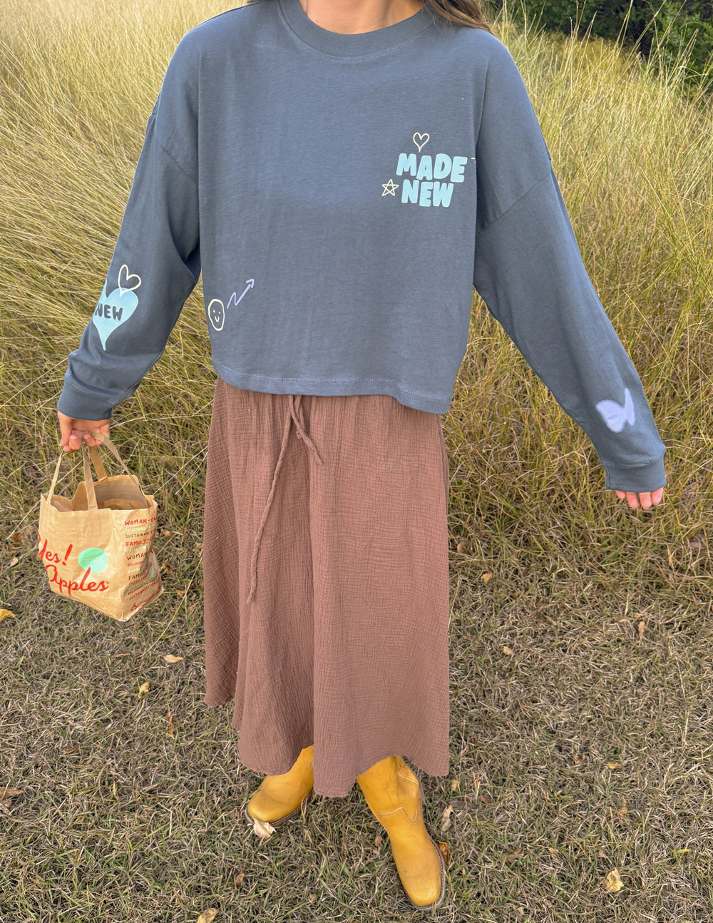 Cropped long-sleeve tee in dark blue with “MADE NEW” logo and heart sleeve print