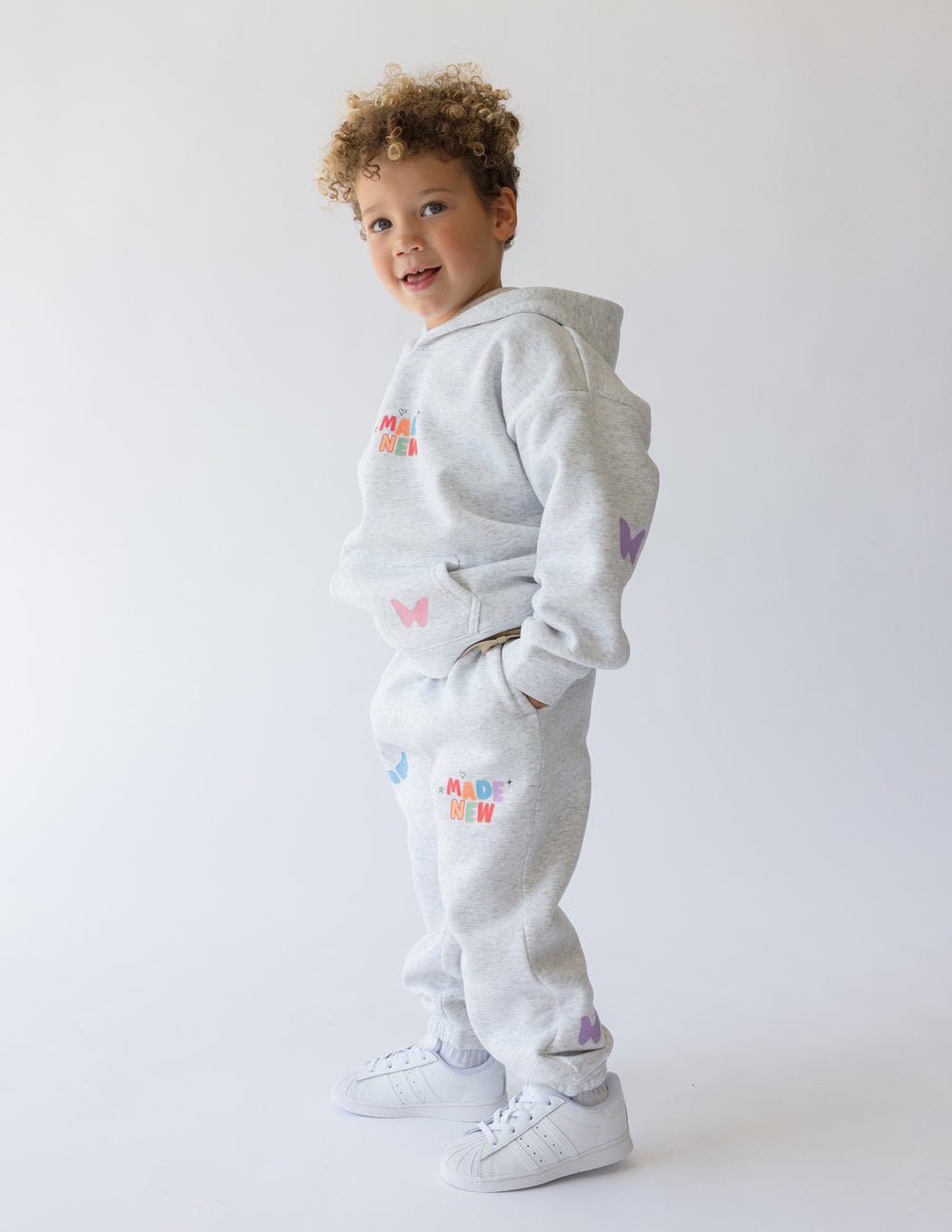 Kids light gray hoodie with hood, kangaroo pocket, and colorful Made New print