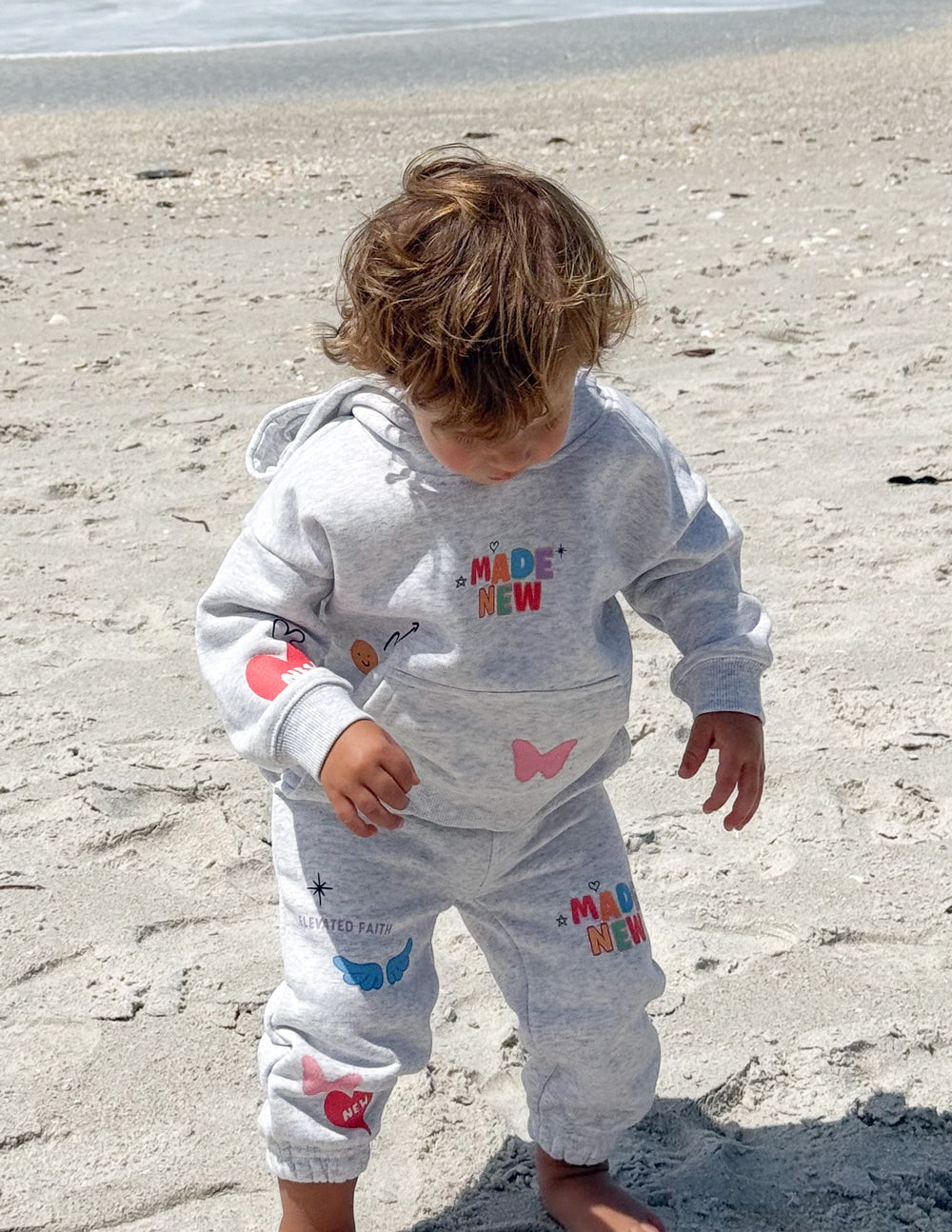 Kids light gray hoodie with kangaroo pocket and colorful front graphic
