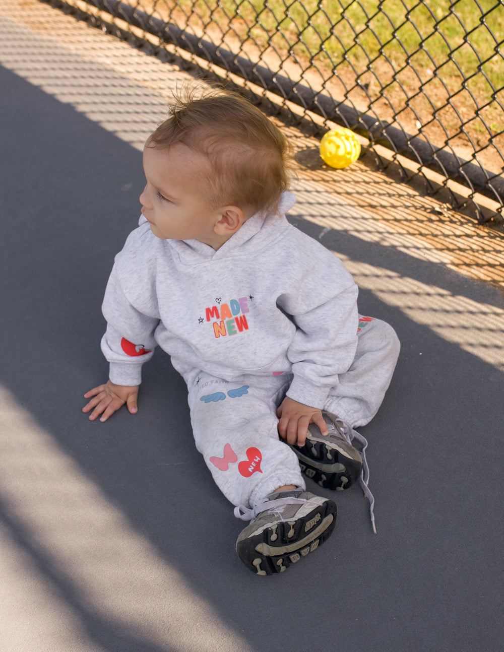 Kids light gray hoodie with colorful front print and kangaroo pocket