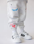 Kids gray fleece sweatpants with elastic cuffs and colorful animal patches
