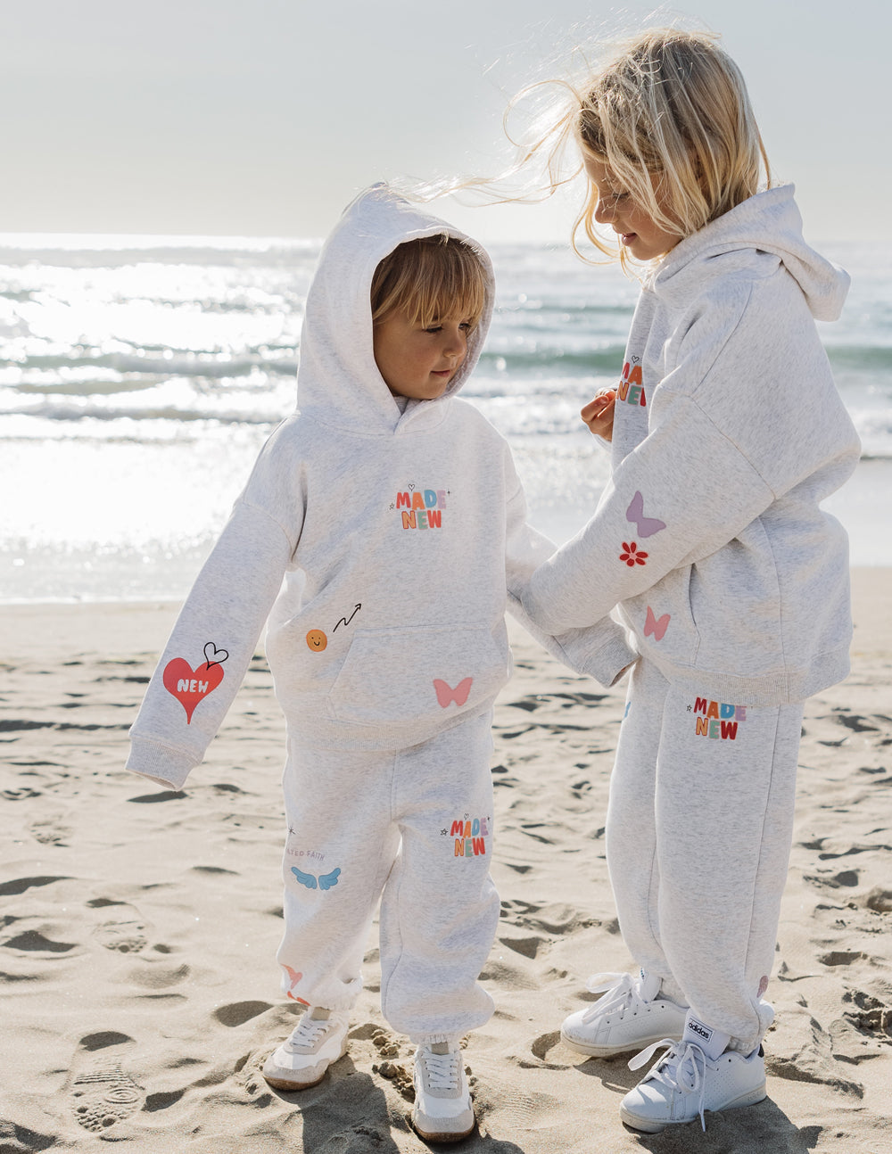 Kids gray sweatpants with elastic cuffs and multicolor butterfly and heart prints