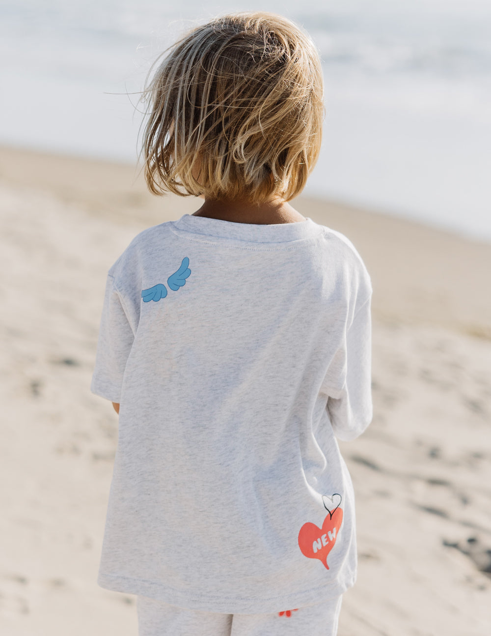 Kids grey tee back with blue dinosaur and red heart 'NEW' graphic