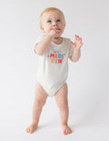 White baby onesie with short sleeves and "MADE NEW" graphic