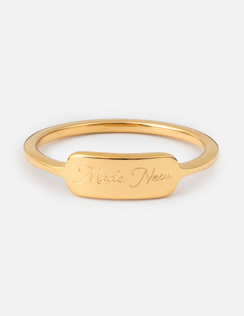 Gold ring with engraved “Made New” band detail