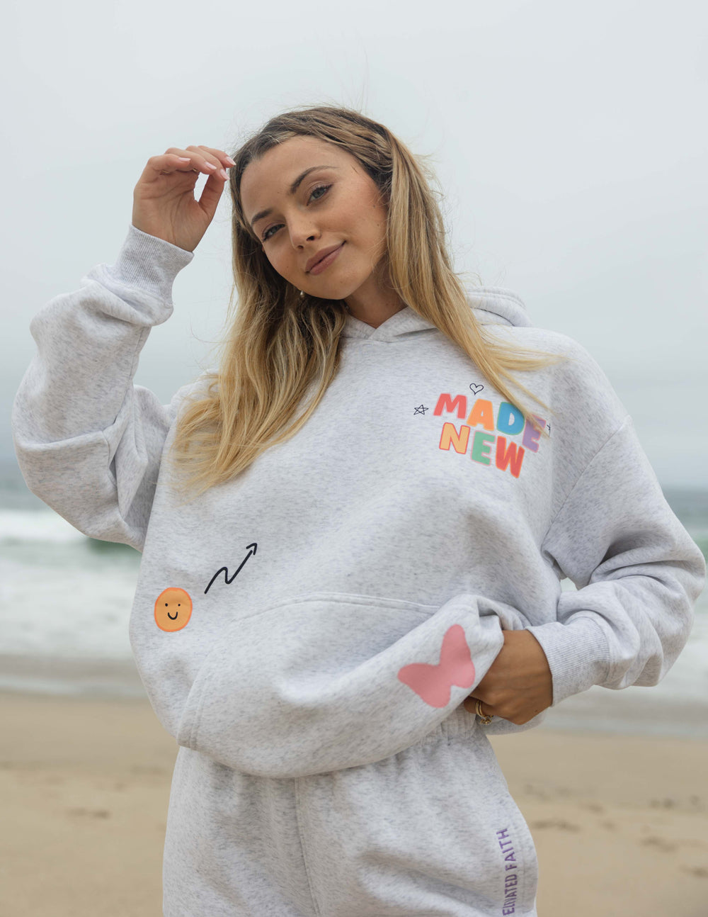 Light gray unisex hoodie with colorful chest graphic, kangaroo pocket and long sleeves