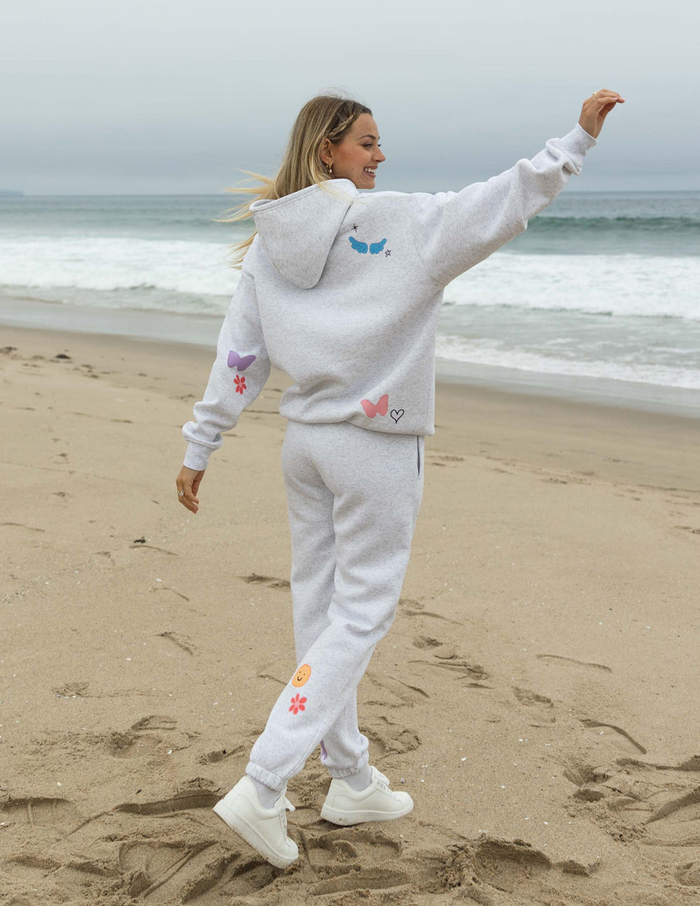 Light gray unisex hoodie with colorful back graphics and drawstring hood