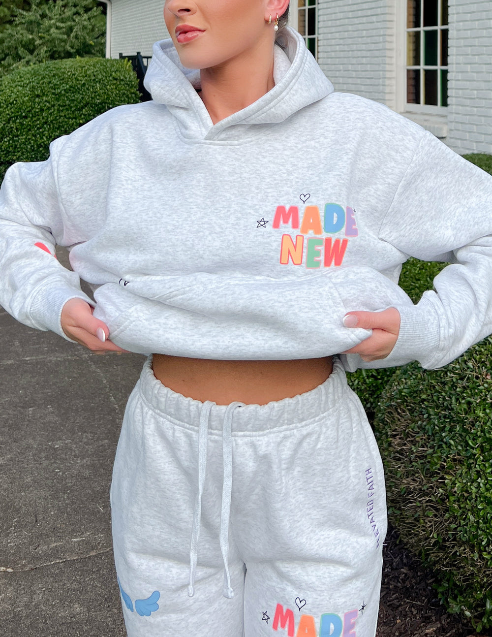 Light gray unisex hoodie with colorful chest logo and front pouch pocket