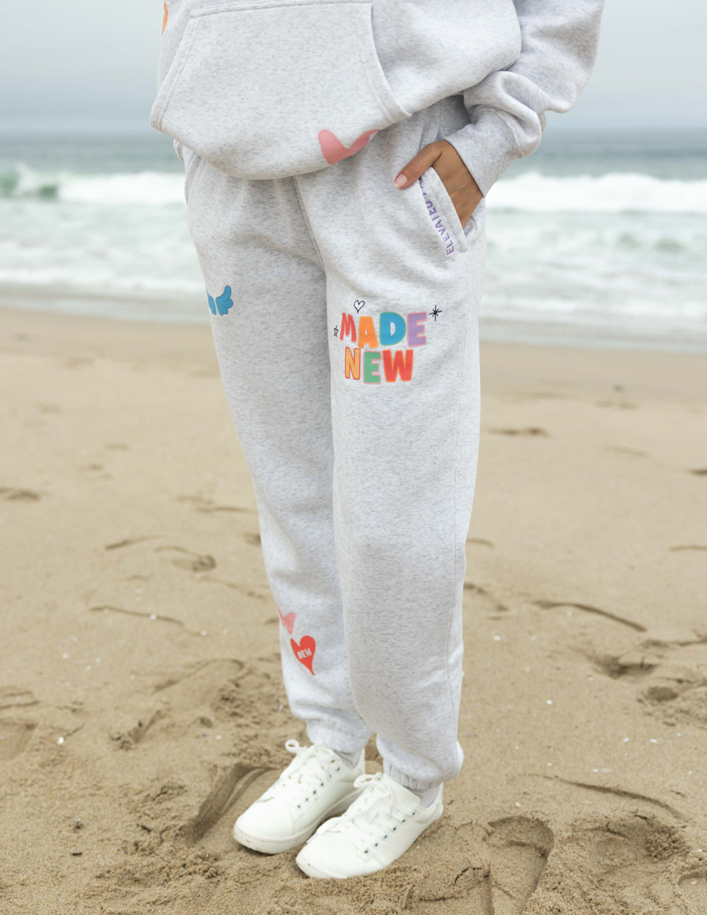 Heather gray unisex sweatpants with colorful "Made New" patch and small graphic icons