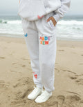 Heather gray unisex sweatpants with colorful "Made New" patch and small graphic icons