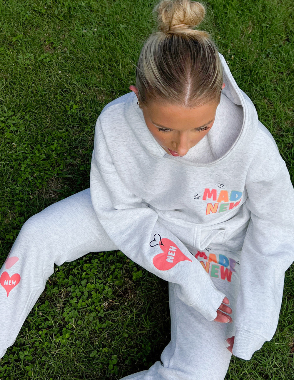Heather gray sweatpants with "Made New" logo and small doodle icons on the leg